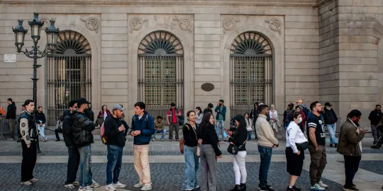 April 24, 2026, Barcelona, Spain: People line up in the Gothic Quarter in front of Barcelona's City Hall as they seek assistance with migrant regularization documents and procedures promoted by the Spanish government, which is expected to grant legal status to around 500,000 migrants. The Gothic Quarter, in the Ciutat Vella district, has the highest proportion of foreign residents in Barcelona and is among the areas with the largest immigrant populations in Catalonia