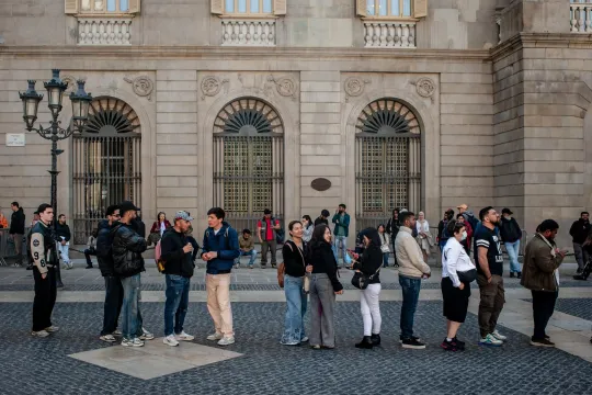 April 24, 2026, Barcelona, Spain: People line up in the Gothic Quarter in front of Barcelona's City Hall as they seek assistance with migrant regularization documents and procedures promoted by the Spanish government, which is expected to grant legal status to around 500,000 migrants. The Gothic Quarter, in the Ciutat Vella district, has the highest proportion of foreign residents in Barcelona and is among the areas with the largest immigrant populations in Catalonia