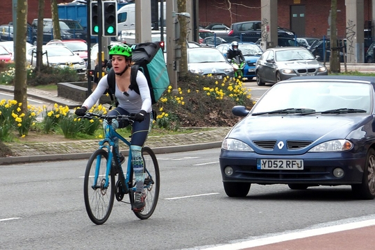 1024px-Deliveroo_Rider_Taking_The_Lane_In_Bristol_(32611782273)_(cropped)